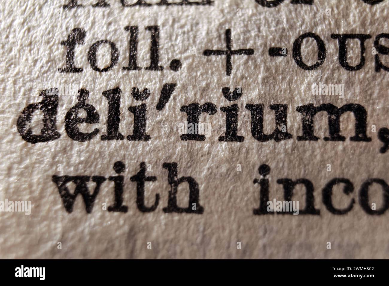 Definition of word delirium on dictionary page, macro close-up Stock Photo