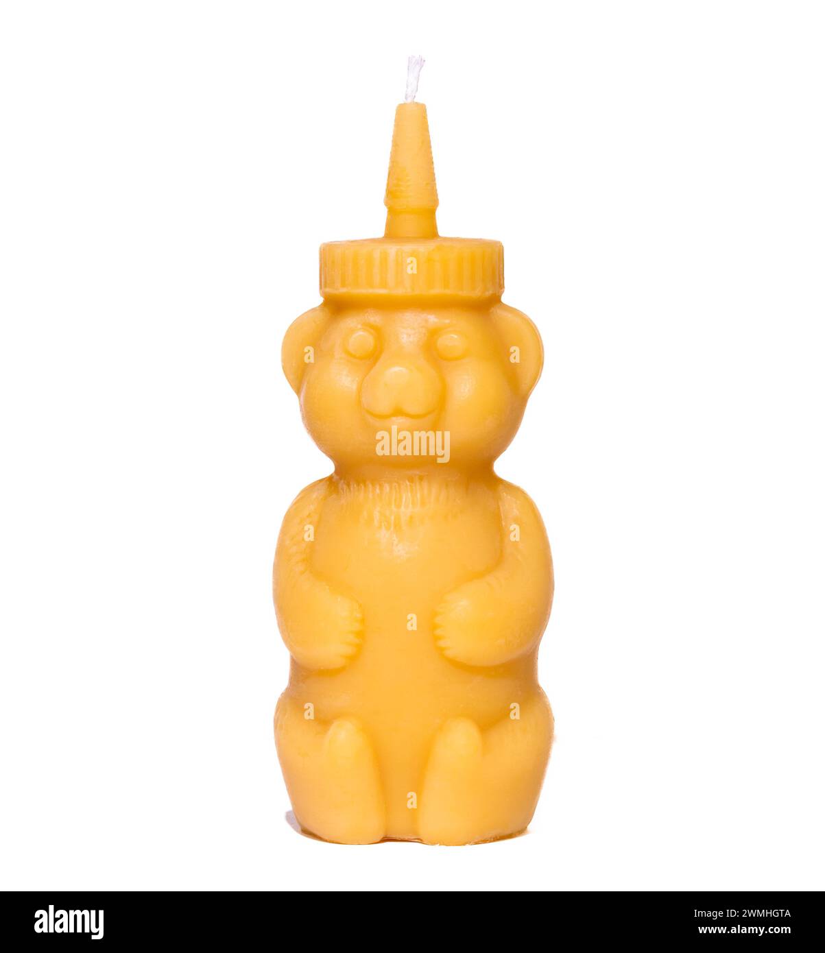 Beeswax candle shaped like a honey bear on white background Stock Photo