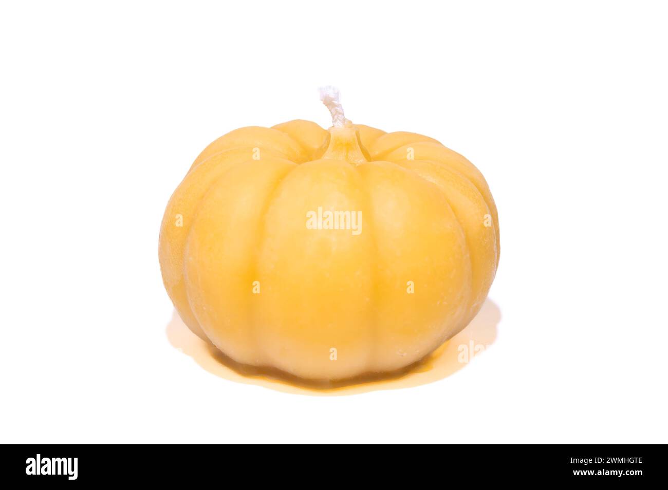 Pumpkin bees wax candle on white background Stock Photo