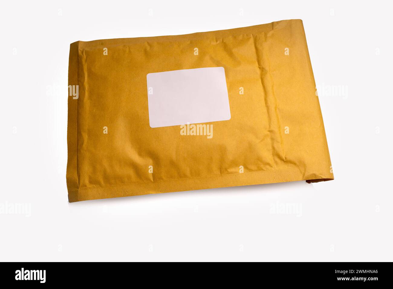 brown paper padded postal envelopes isolated on a white background with blank address label Stock Photo