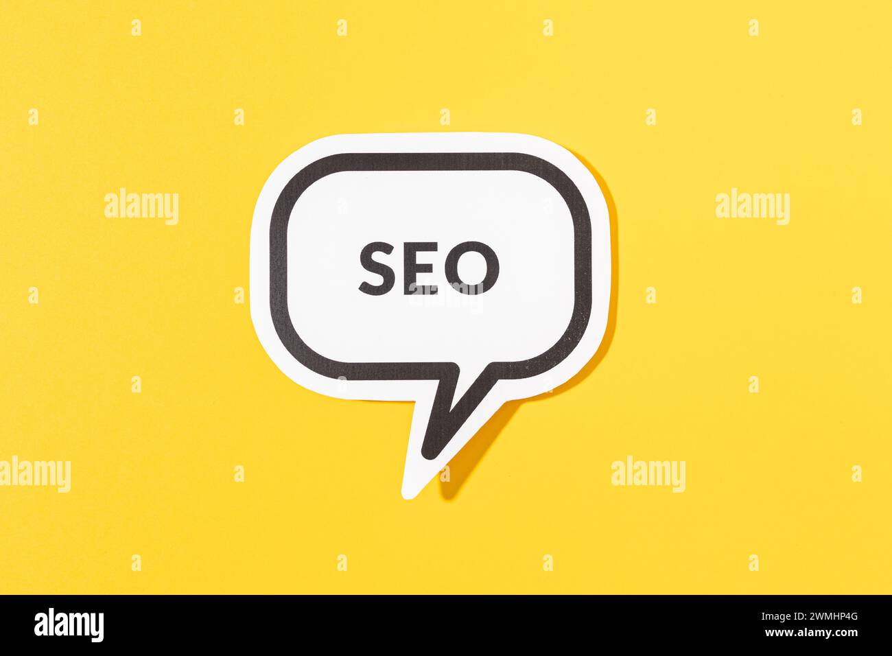 SEO text on speech bubble isolated on yellow background Stock Photo