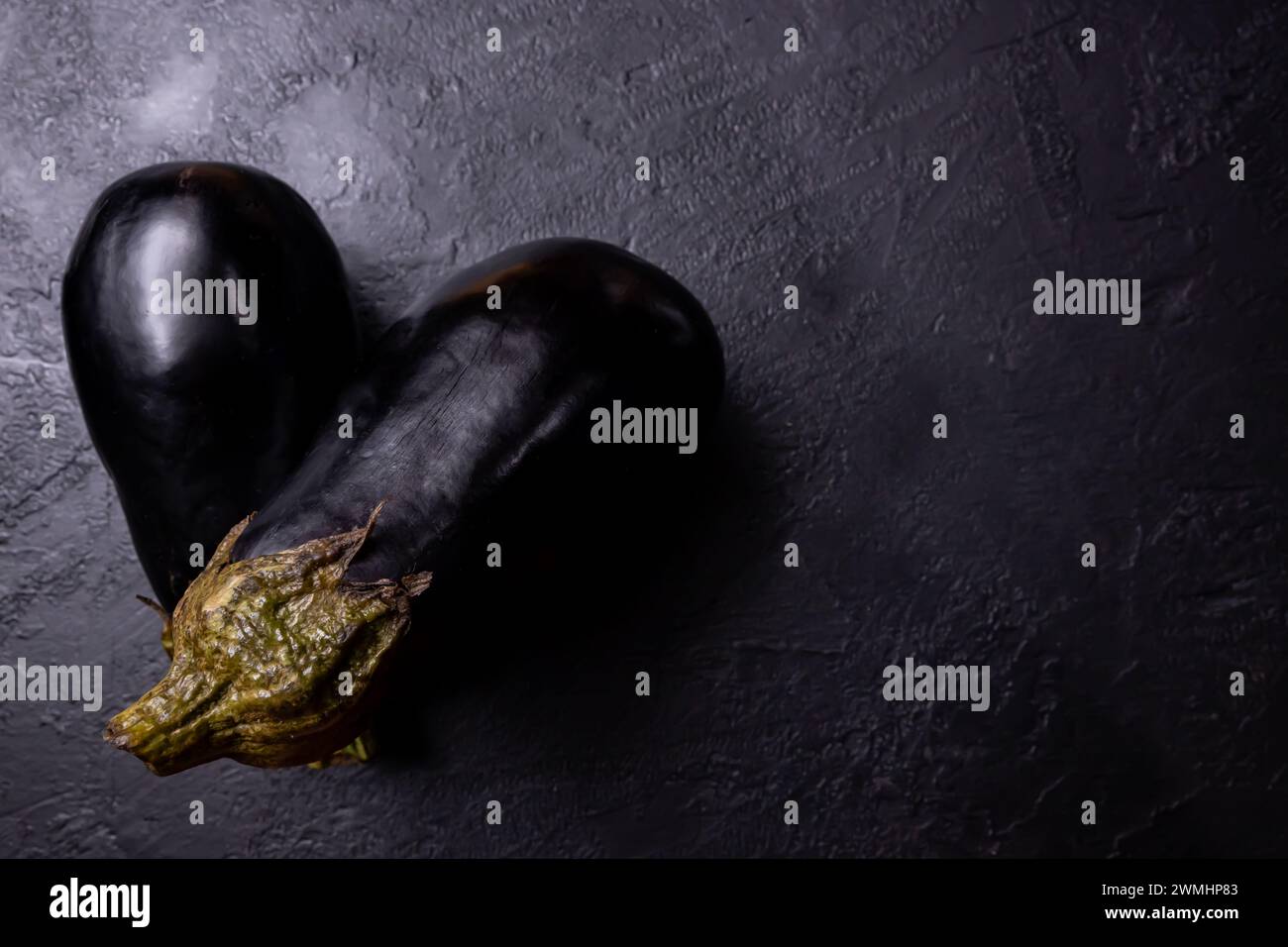 Composition of two eggplants on a dark background. Stock Photo