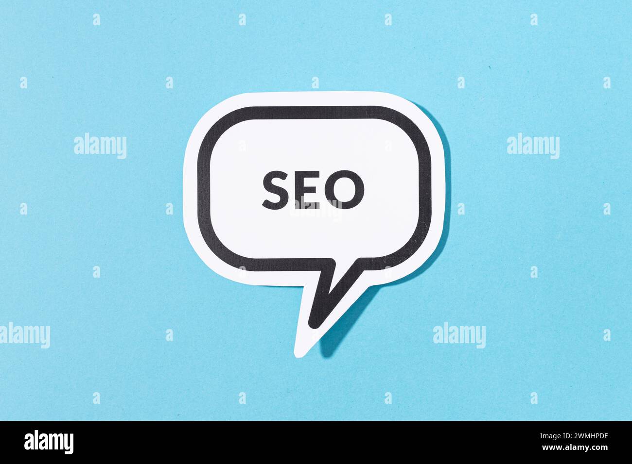 SEO text on speech bubble isolated on blue background Stock Photo