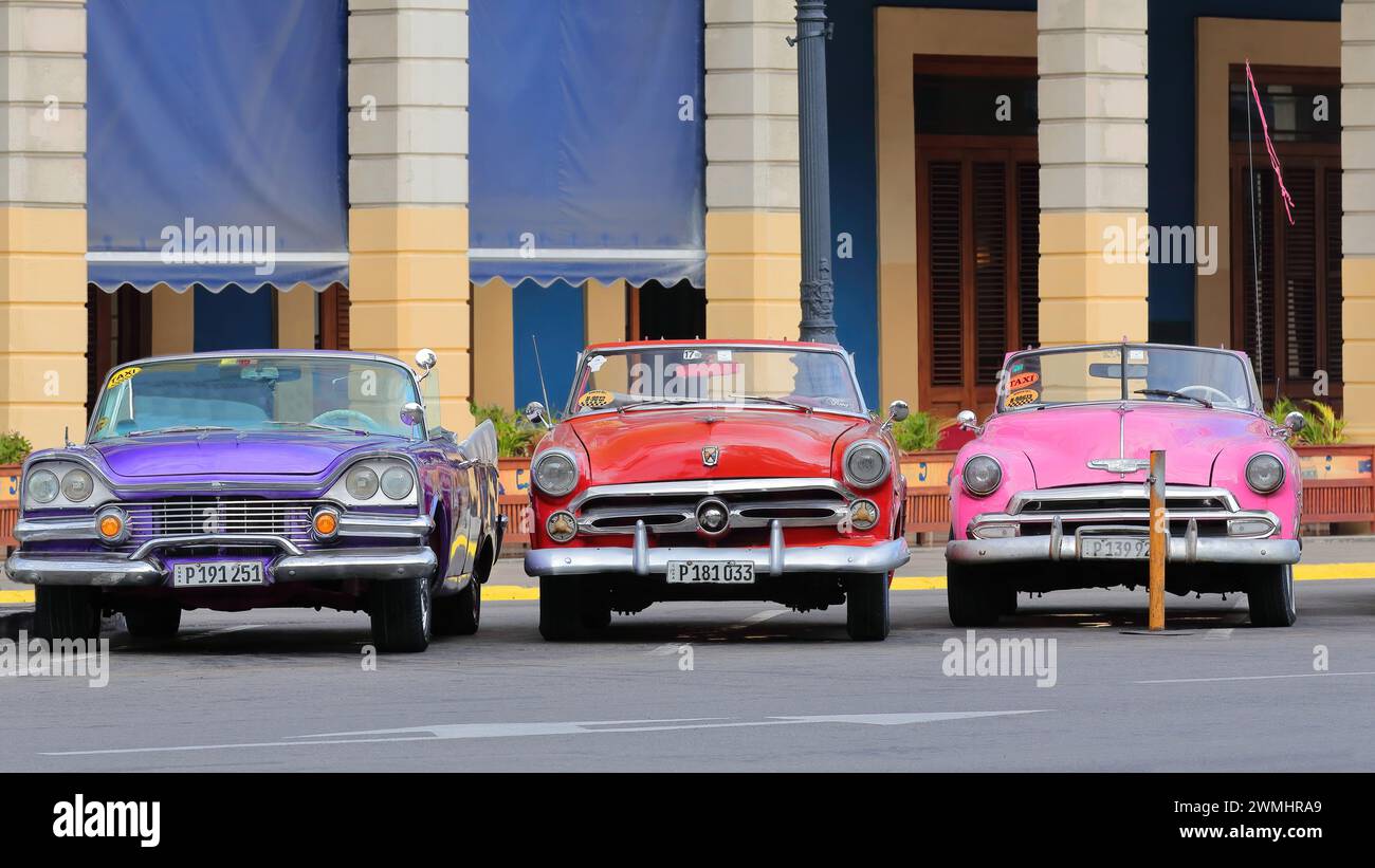 021 Classic purplish blue-red-pink American cars -almendron, yank tank Dodge-Ford-Chevrolet- from 1957-1952 stationed on Paseo del Prado. Havana-Cuba. Stock Photo