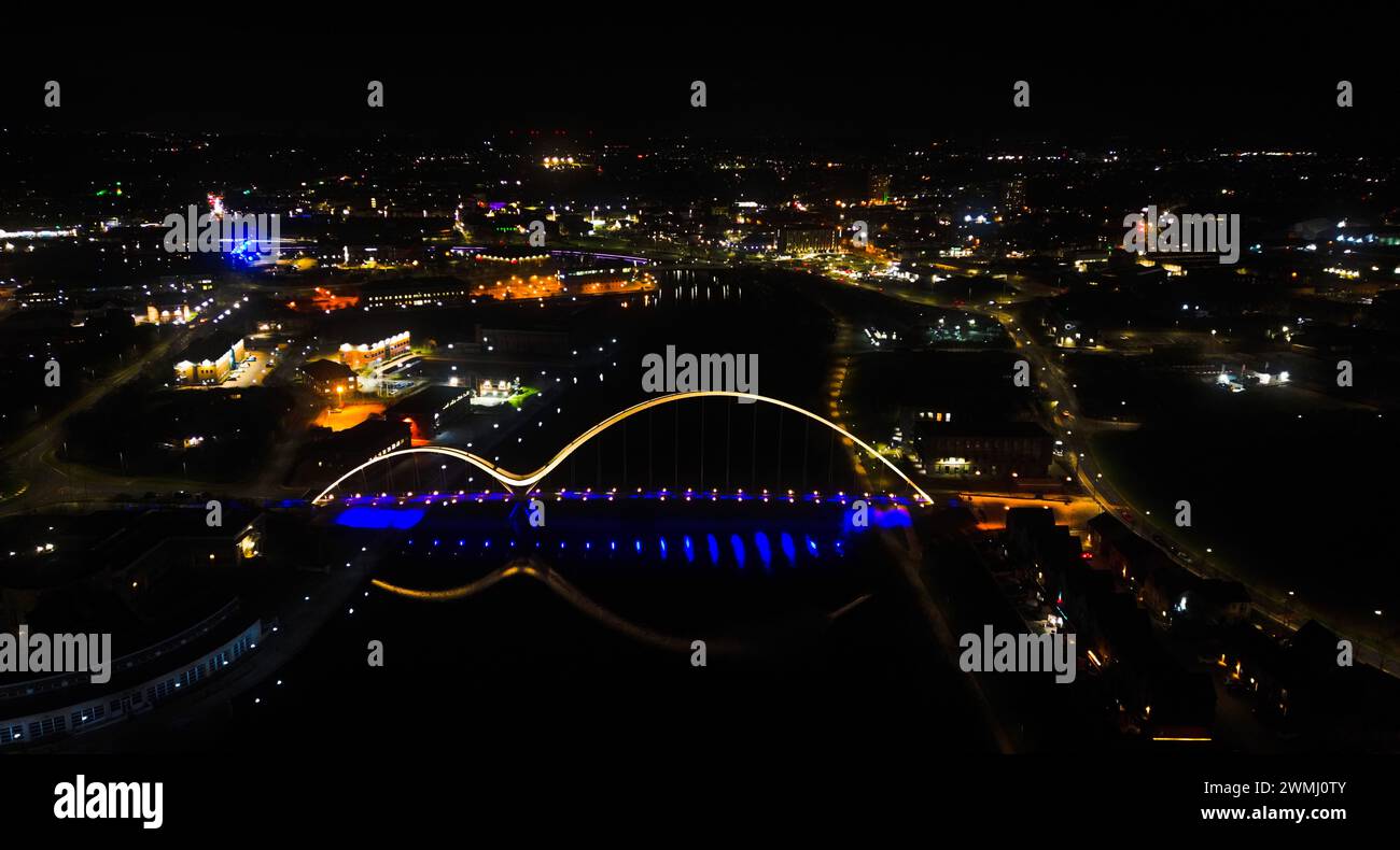Aerial view of a city illuminated at night, showcasing vibrant lights ...