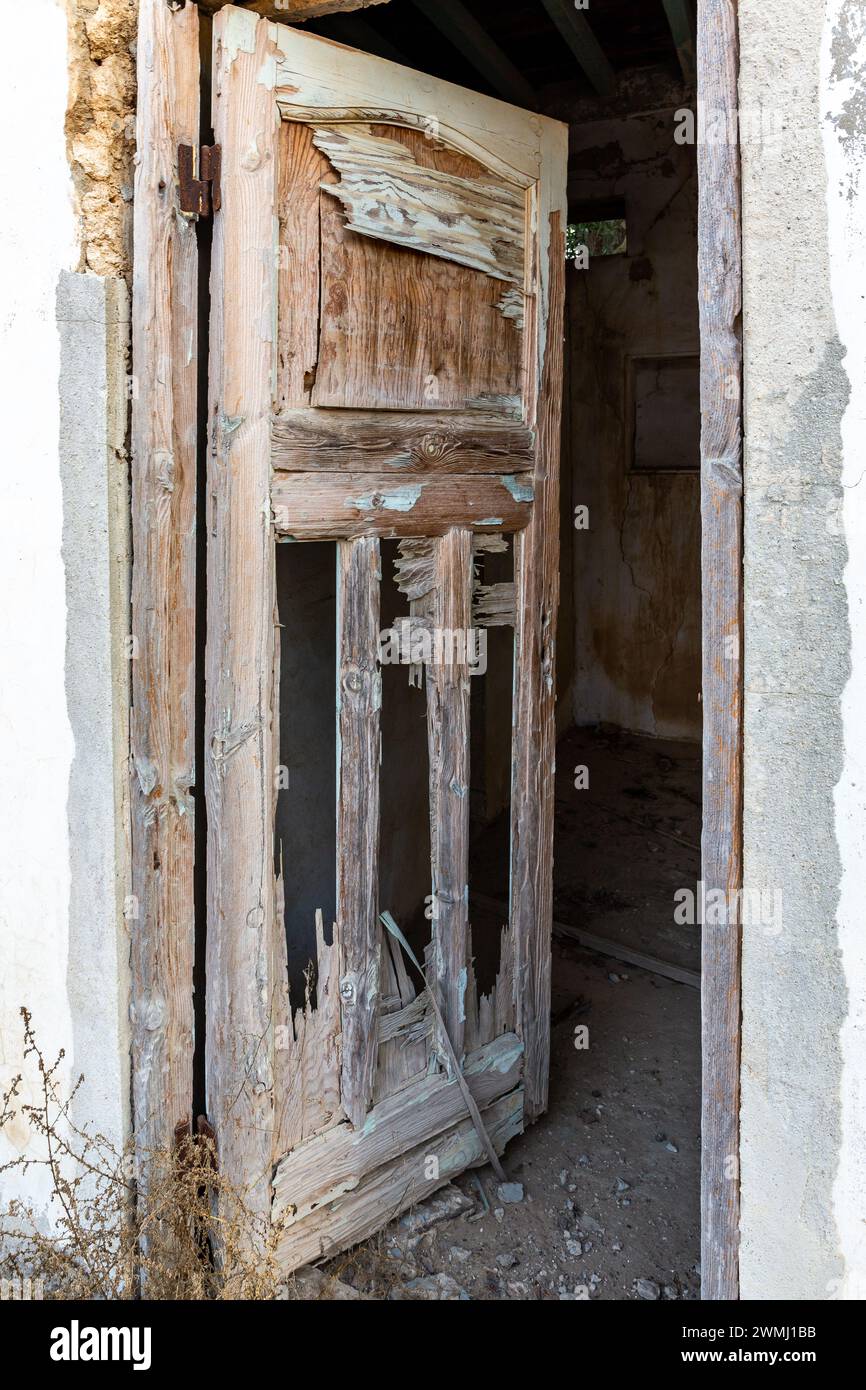 Old wooden demolished doors leading to haunted building in Al Jazirah Al Hamra abandoned town in Ras Al Khaimah, United Arab Emirates Stock Photo