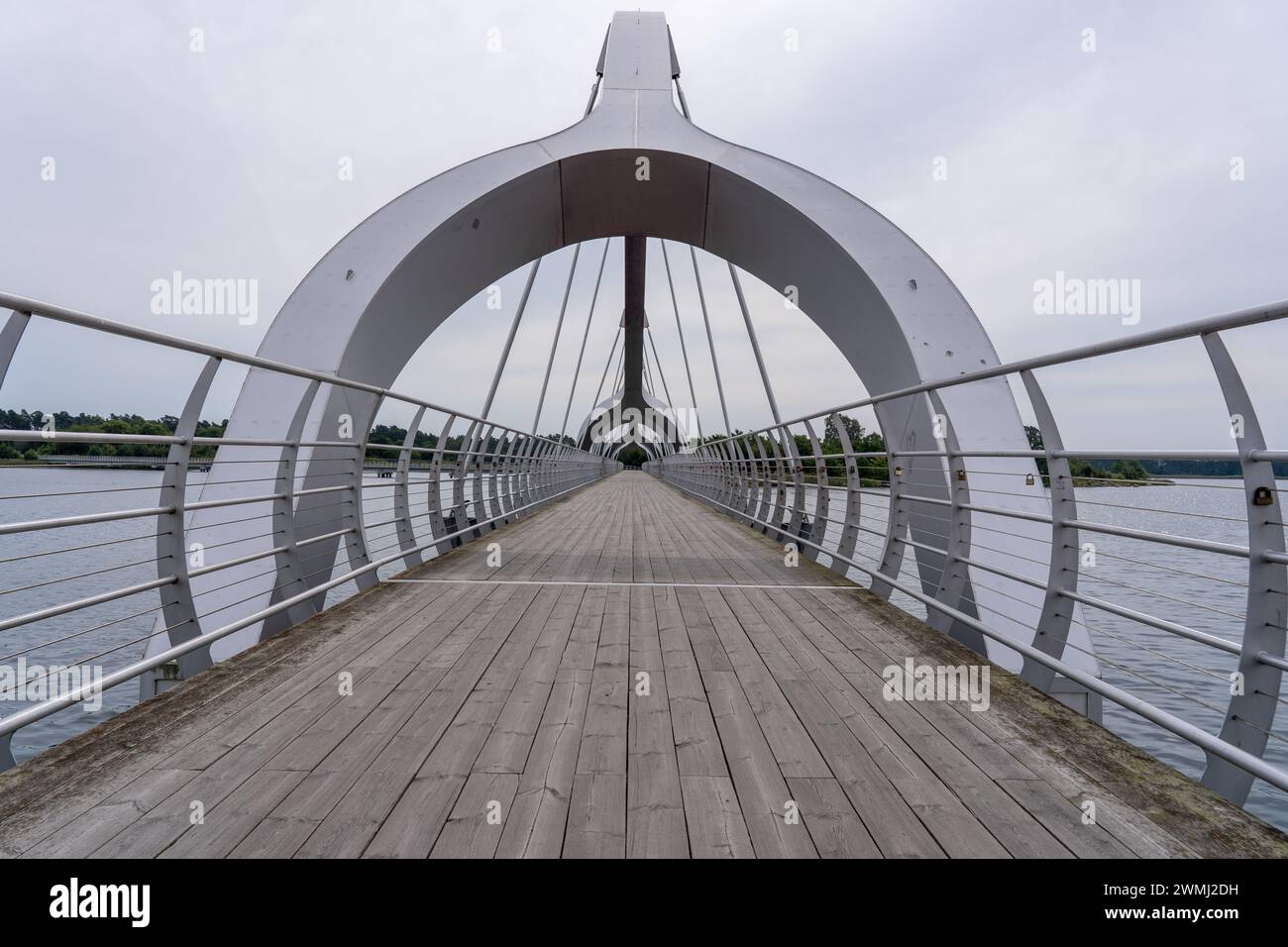 A bridge stretches over a lake, disappearing into the distance, Sweden ...