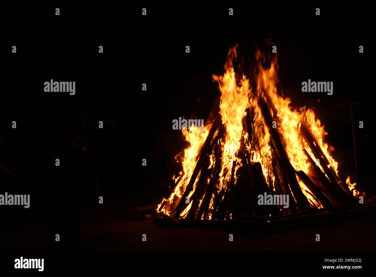 Warmth and Light: Bonfire Illuminates the Night Stock Photo