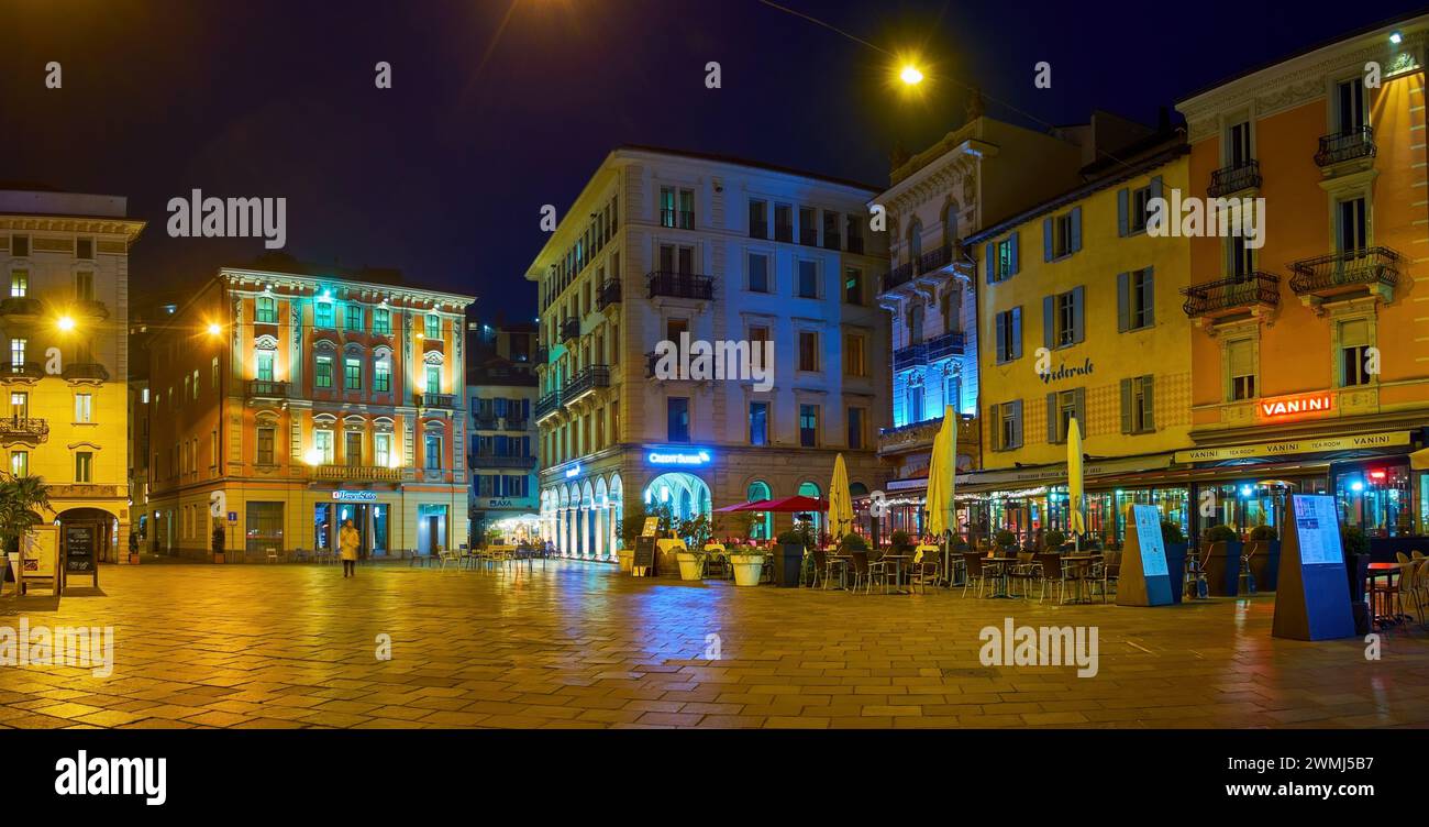 LUGANO, SWITZERLAND - MARCH 17, 2022: The bustling outdoor patios on  Piazza della Riforma at night, on March 17 in Lugano, Switzerland Stock Photo