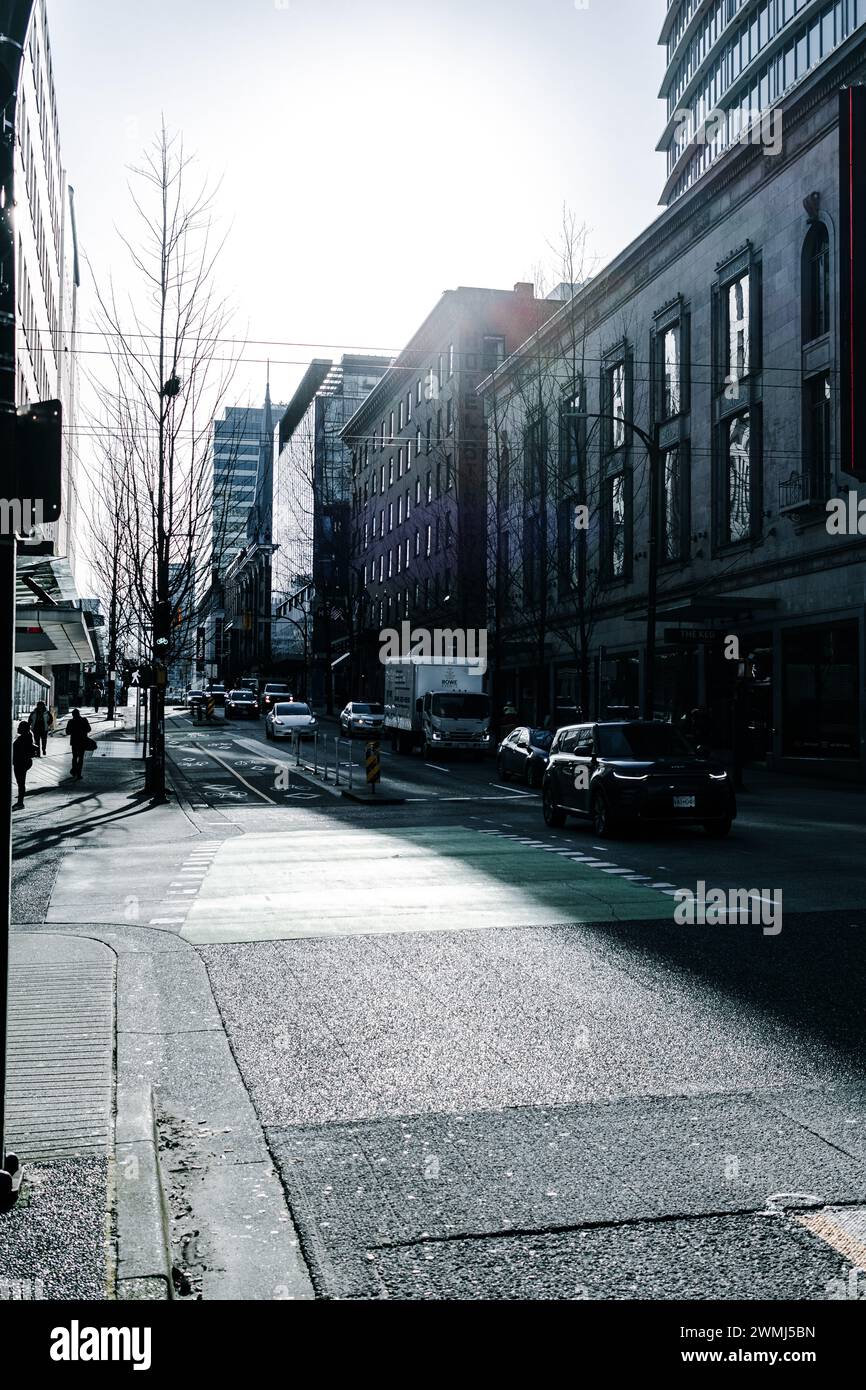Vancouver, Canada - Feb 9 2024: A view of Dunsmuir Street looking east, intersected by Granville Street, with on-coming cars and people walking. Stock Photo