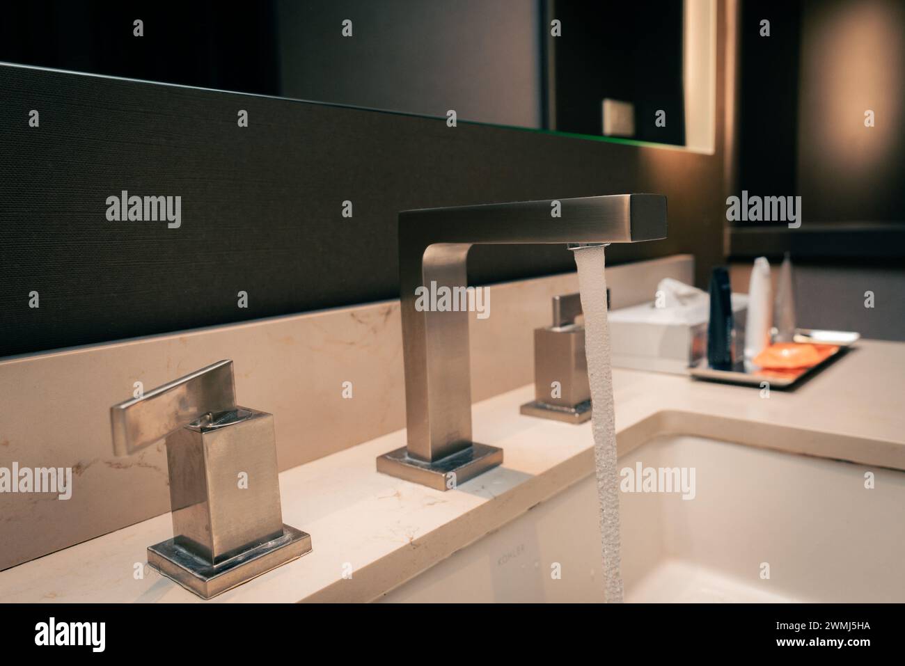 hotel room bathroom sink and metal faucet Stock Photo - Alamy