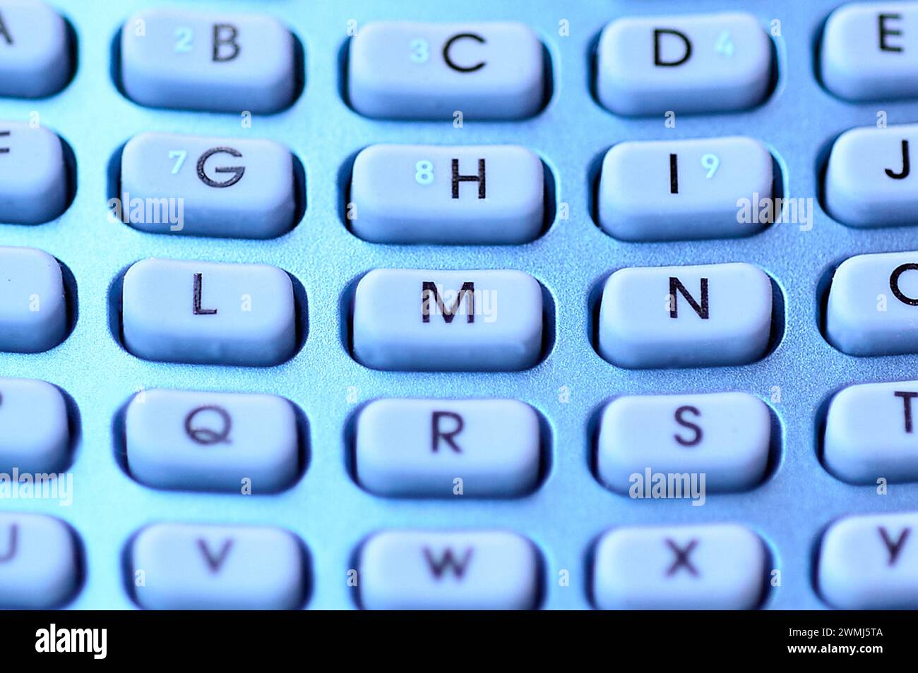 Image of a blue alphabetic keyboard, highlighting the texture and alphabetical characters. Stock Photo