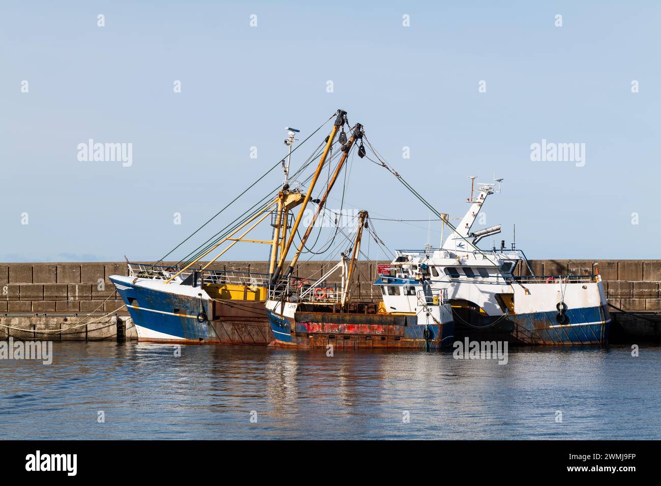 26 February 2024. Buckie Harbour,Moray,Scotland. This is the Little and Large Fishing Boats berthed alongside each other on a sunny day. Stock Photo