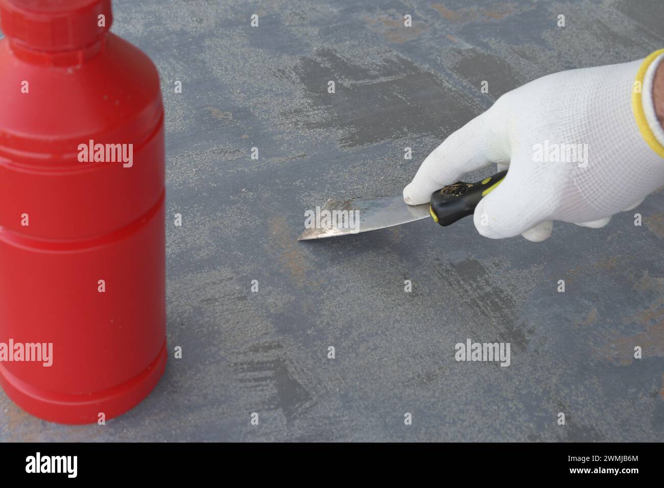 Using special chemicals for removing old paint from a wooden surface of an object Stock Photo