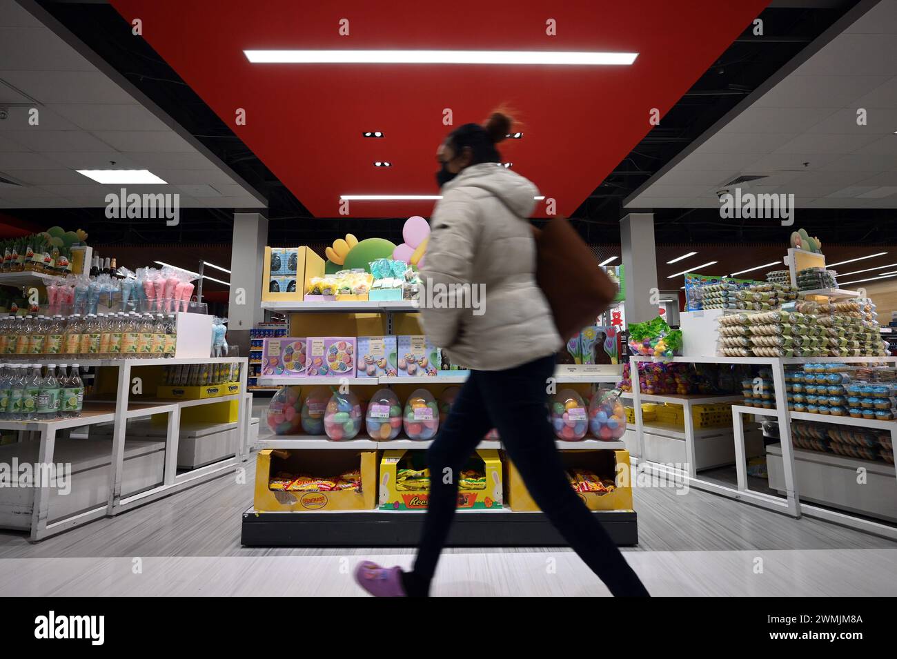 A woman walks past a display of easter chocolates and toys at a Target