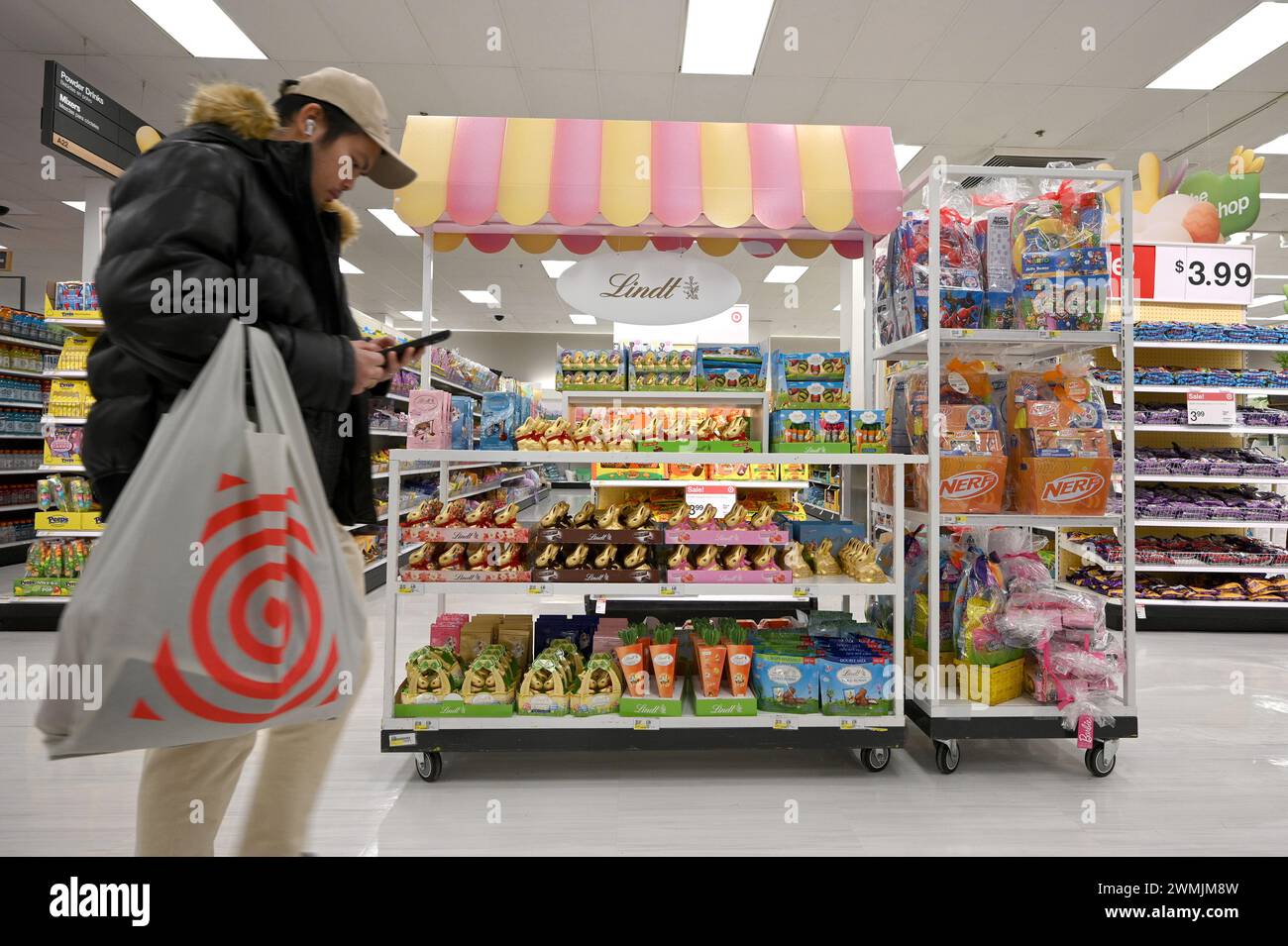 New York, USA. 26th Feb, 2024. A man walks past a display of Lindt