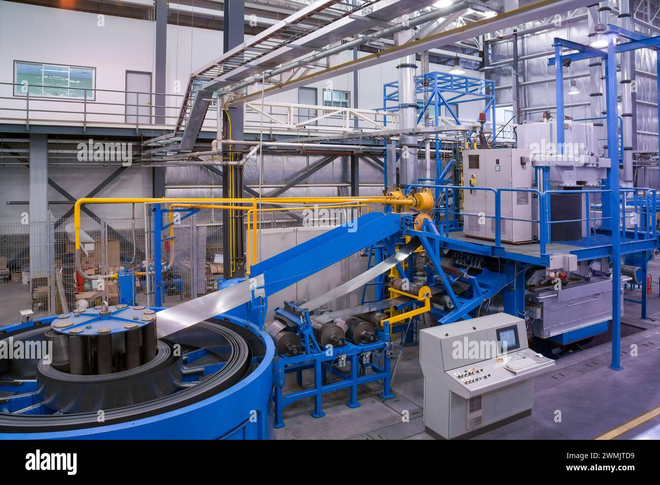 A metal roll sheet manufacturing plant with automated Machinery. Stock Photo