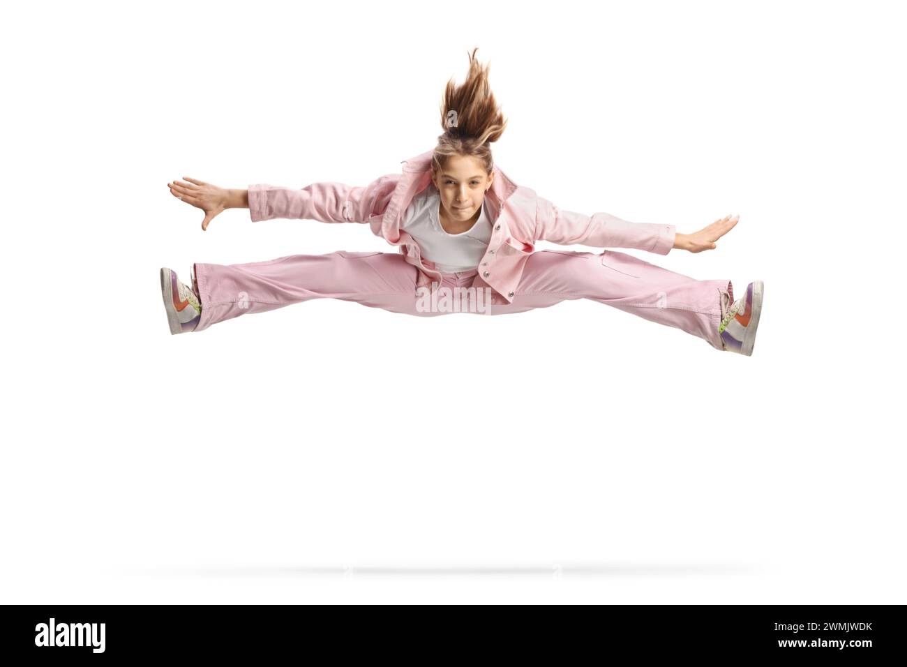 Teenage girl leaping in the air and making a split isolated on white ...