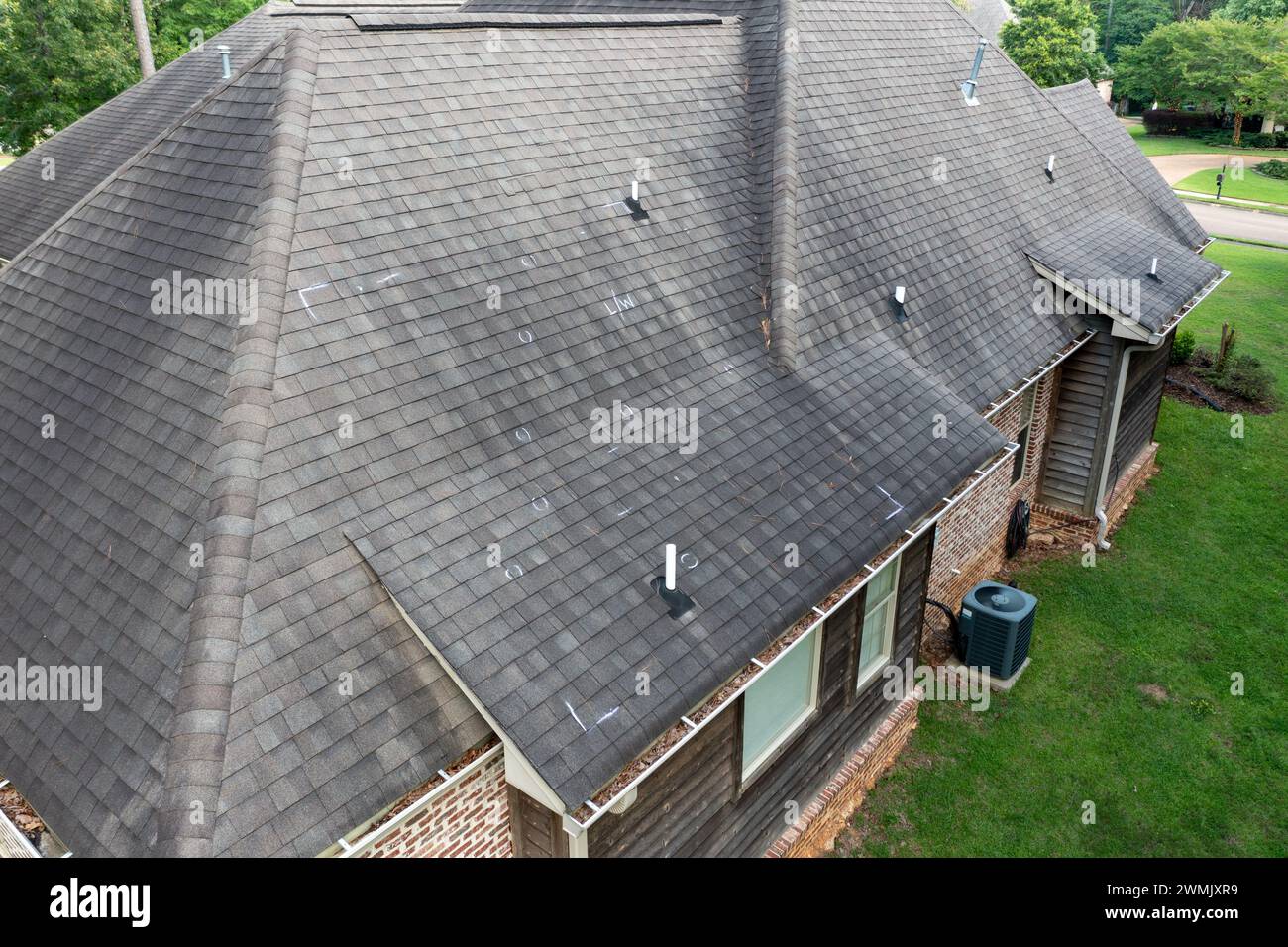 Roof with hail damage and chalk markings from inspection Stock Photo