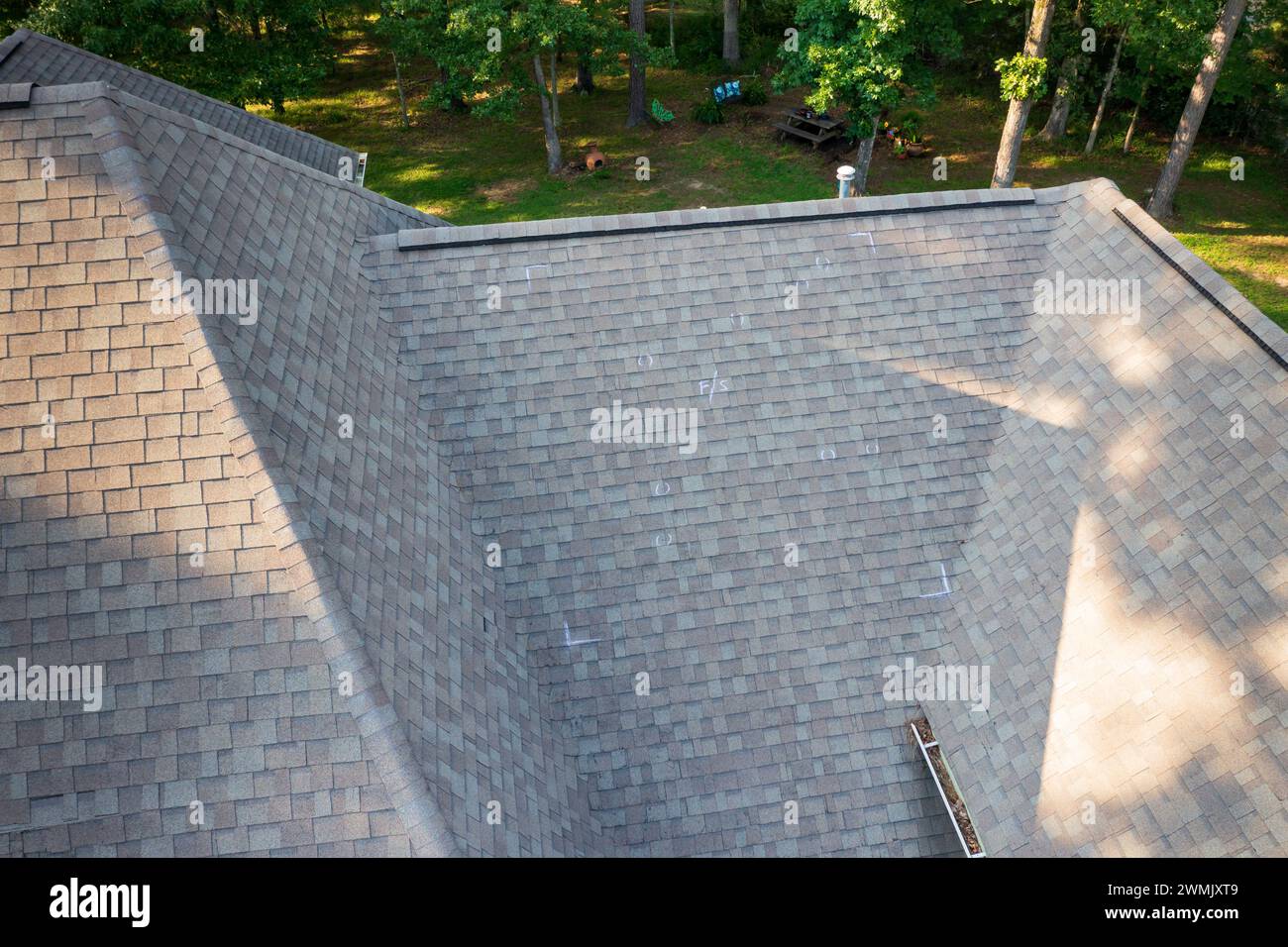 Roof with hail damage and chalk markings from inspection Stock Photo