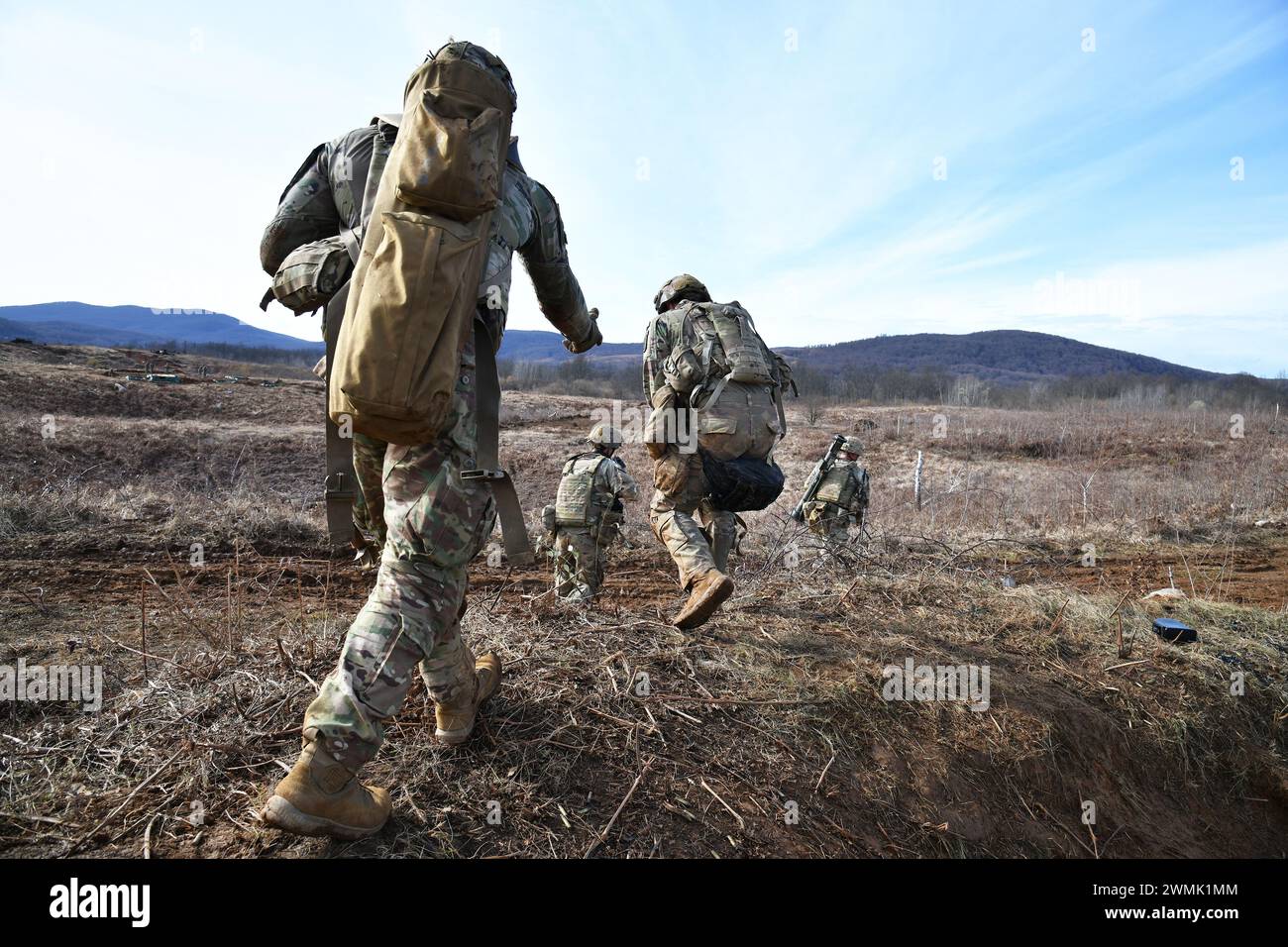 U.S. Army Paratroopers assigned to the 1st Battalion, 503rd Infantry Regiment, 173rd Airborne Brigade, move towards an objective during team live-fire and tactical movement training  as part of Eagle Ursa at the training range in Slunj, Croatia, Feb. 25, 2024. The 173rd Airborne Brigade is the U.S. Army's Contingency Response Force in Europe, providing rapidly deployable forces to the United States European, African, and Central Command areas of responsibility. Forward deployed across Italy and Germany, the brigade routinely trains alongside NATO allies and partners to build partnerships and s Stock Photo