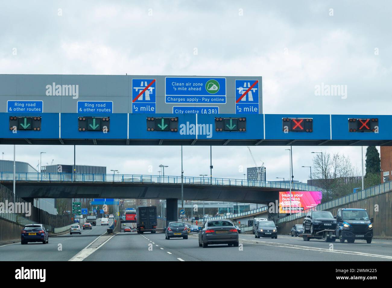 Signage on the A38 Aston Exressway that leading into Birmingham City Centre. Cllean Air Zone signs can be seen on gantries over the road warning motorists that there is a fee to pay if their car is not compliant. Birmingham has a Clean Air Zone in the City Centre. NOTE, the pictures were taken from the passenger seat of a car not driven by the photographer. Stock Photo