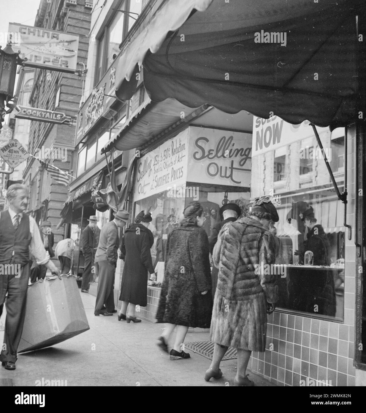 San Francisco, California. A close-out sale- prior to evacuation- at store operated by proprietor of Japanese ancestry on Grant Avenue in Chinatown. The evacuees of Japanese descent will be housed in War Relocation Authority centers for the duration. Dates This item was produced or created on April 4, 1942. Stock Photo