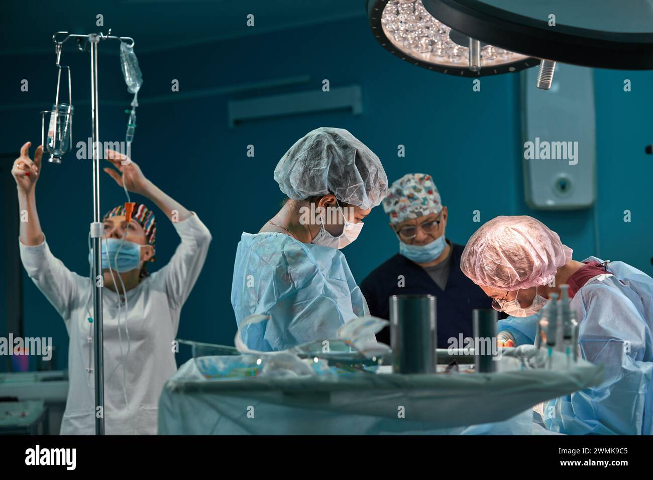 Group of surgeons in operating theater. Medical team performing surgery ...