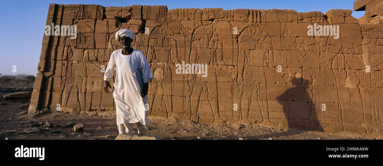 Sudanese man standing next to Egyptian ruins, a Nubian king's tomb from the 25th dynasty. El-Kurru was one of the royal cemeteries used by the Nubi... Stock Photo
