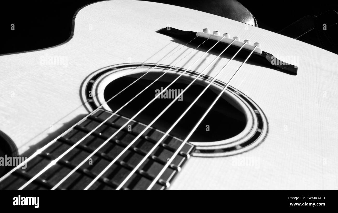 Black and white close up of the top of a steel string acoustic guitar Stock Photo