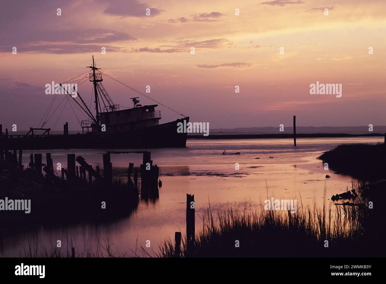 Fishing boat silhouetted at twilight; United States of America Stock Photo