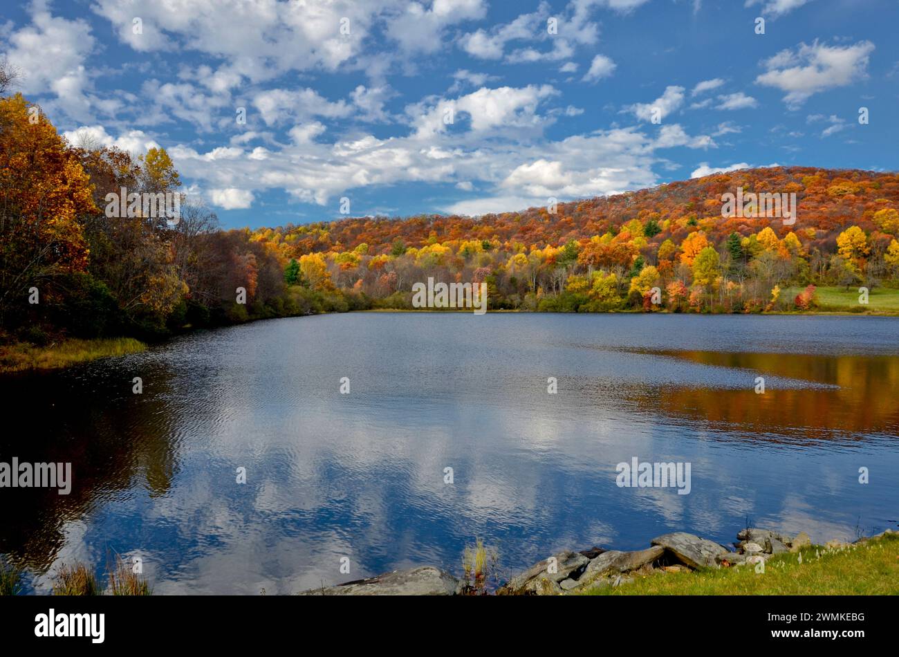 Autumn scene in the Blue Ridge Mountains with Flattop Mountain Lake surrounded by vibrant autumn coloured foliage in North Carolina, USA Stock Photo