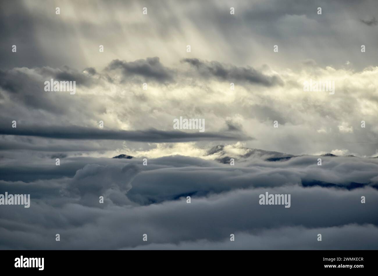 Sunlight shines through clouds on a sea of clouds below; Fairview, North Carolina, United States of America Stock Photo