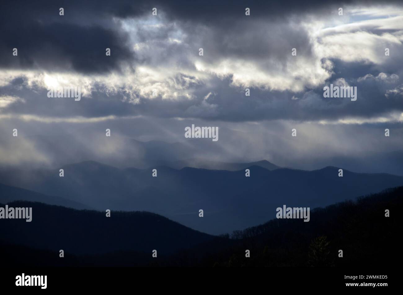 Storm clouds with sunlight over mountain range; Fairview, North Carolina, United States of America Stock Photo
