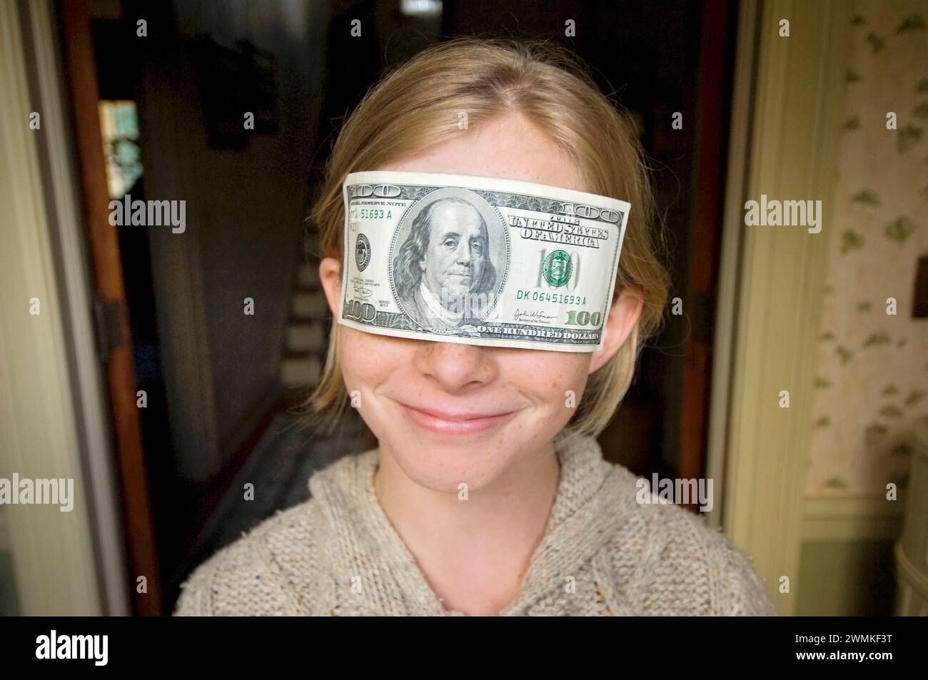Girl blinded by money; Lincoln, Nebraska, United States of America Stock Photo