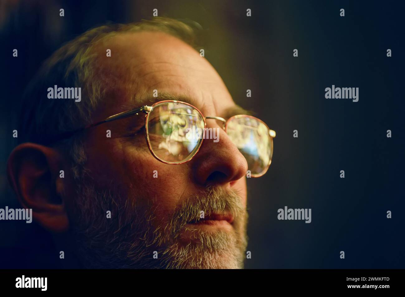 Man in glasses with stained glass windows reflected in them; Lincoln, Nebraska, United States of America Stock Photo
