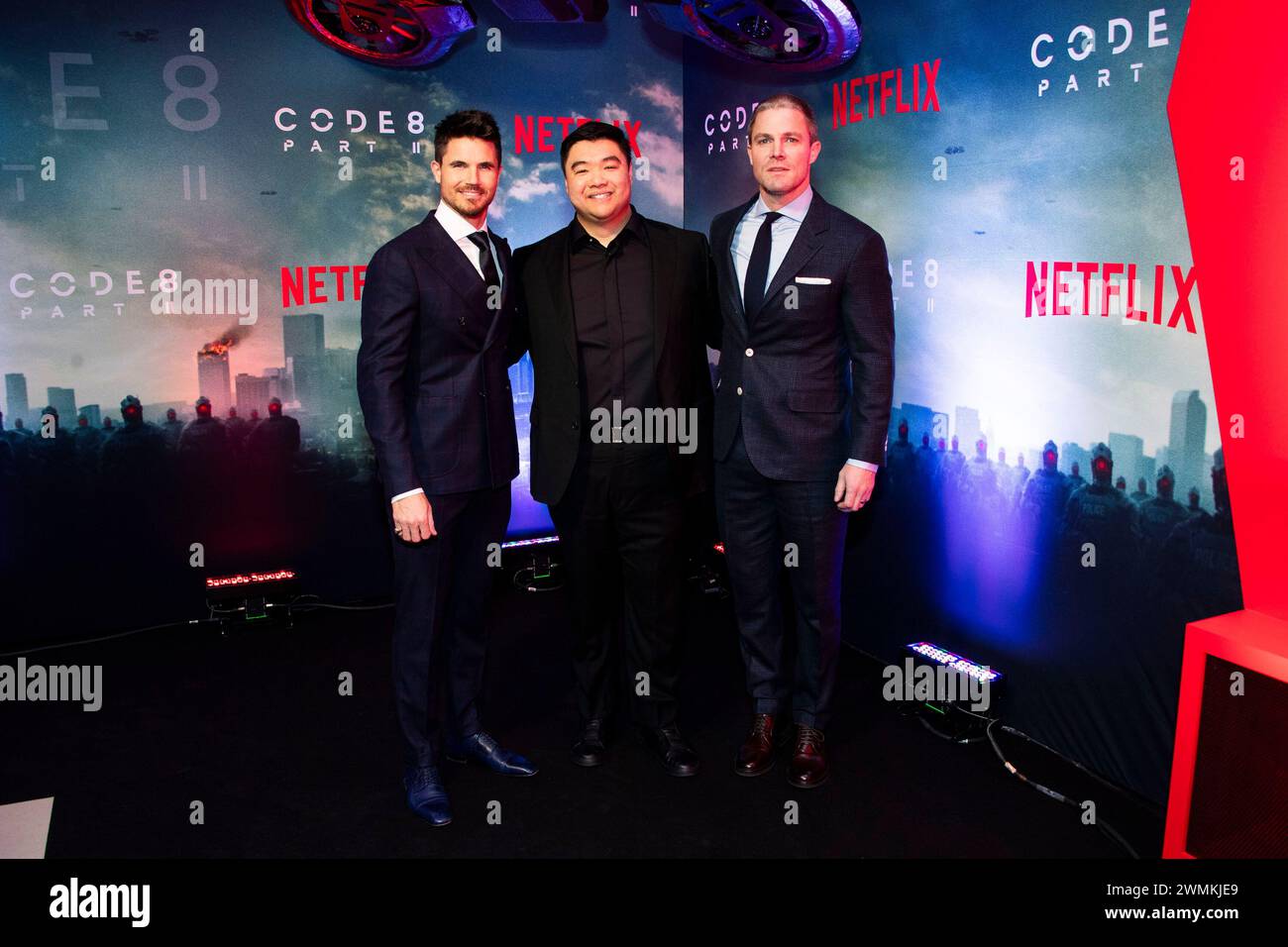 From left, Robbie Amell, director Jeff Chan and Stephen Amell arrive at ...