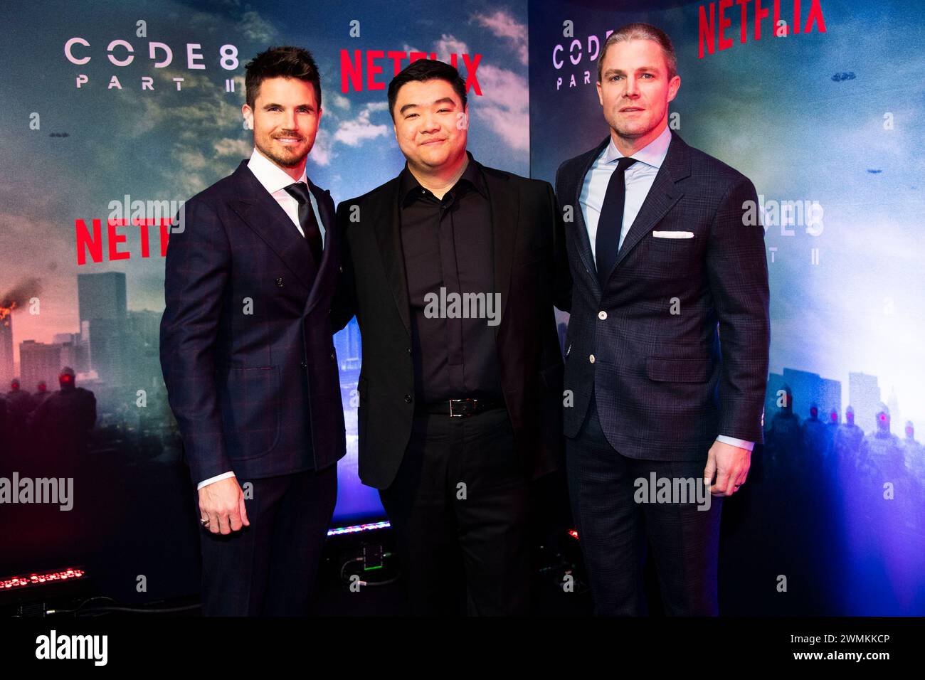 From left, Robbie Amell, director Jeff Chan and Stephen Amell arrive at ...