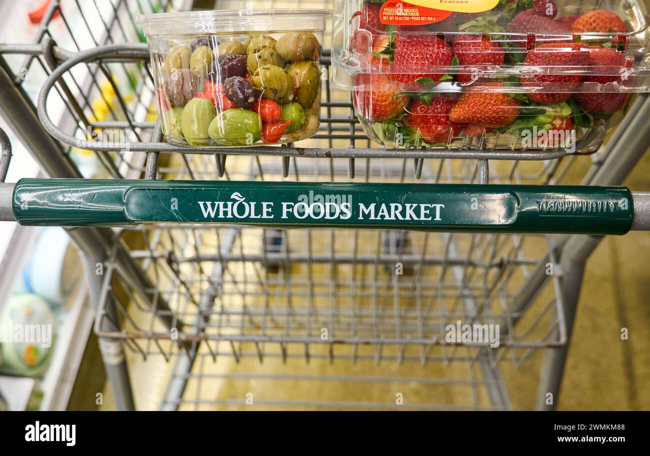 Dallas TX, USA - February 25, 2024: Cart of Whole Foods Market with groceries. Owned by Amazon, Whole Foods a US grocery chain sells food free of arti Stock Photo