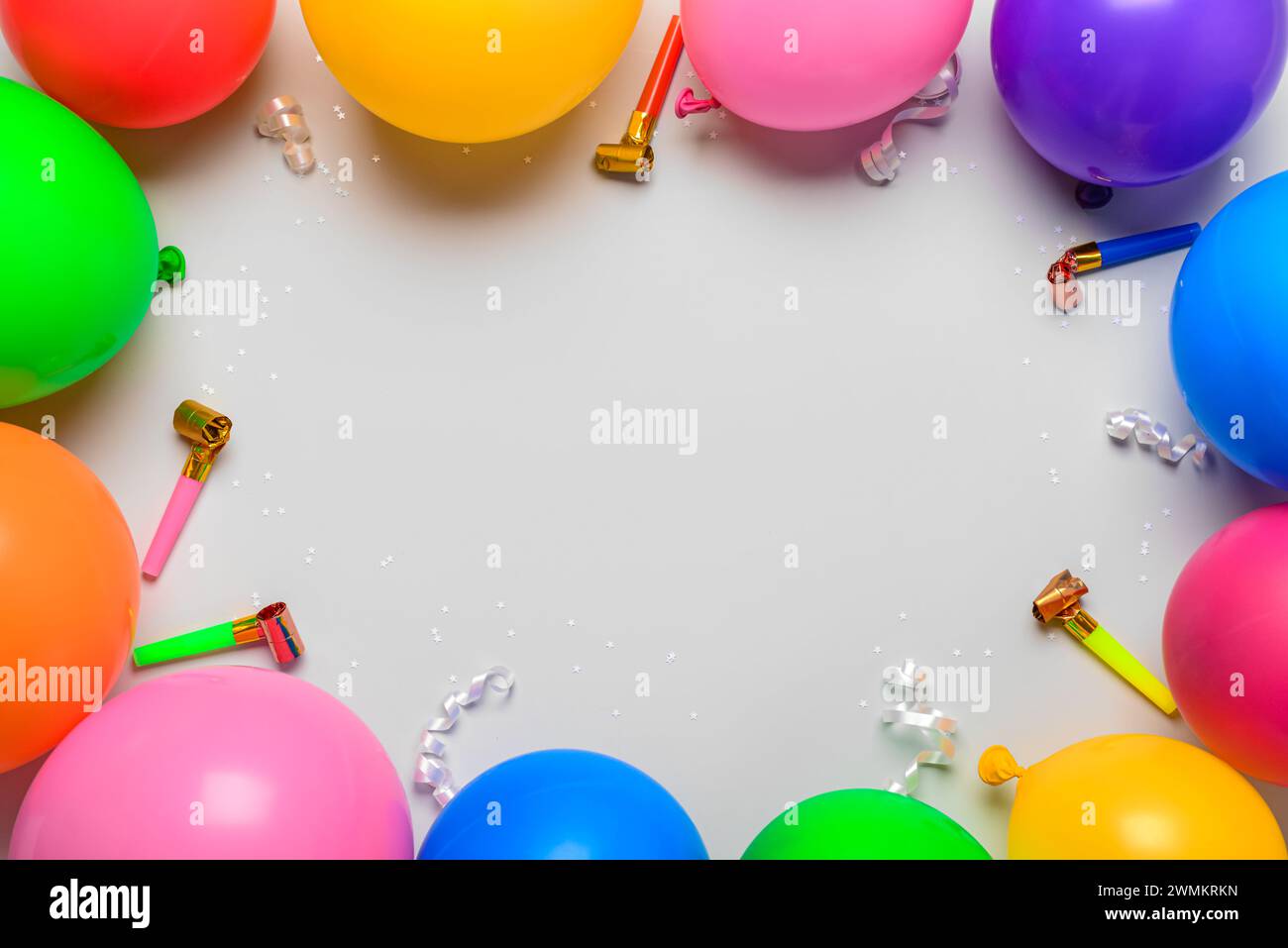 Frame made of balloons and party horns on white background Stock Photo ...