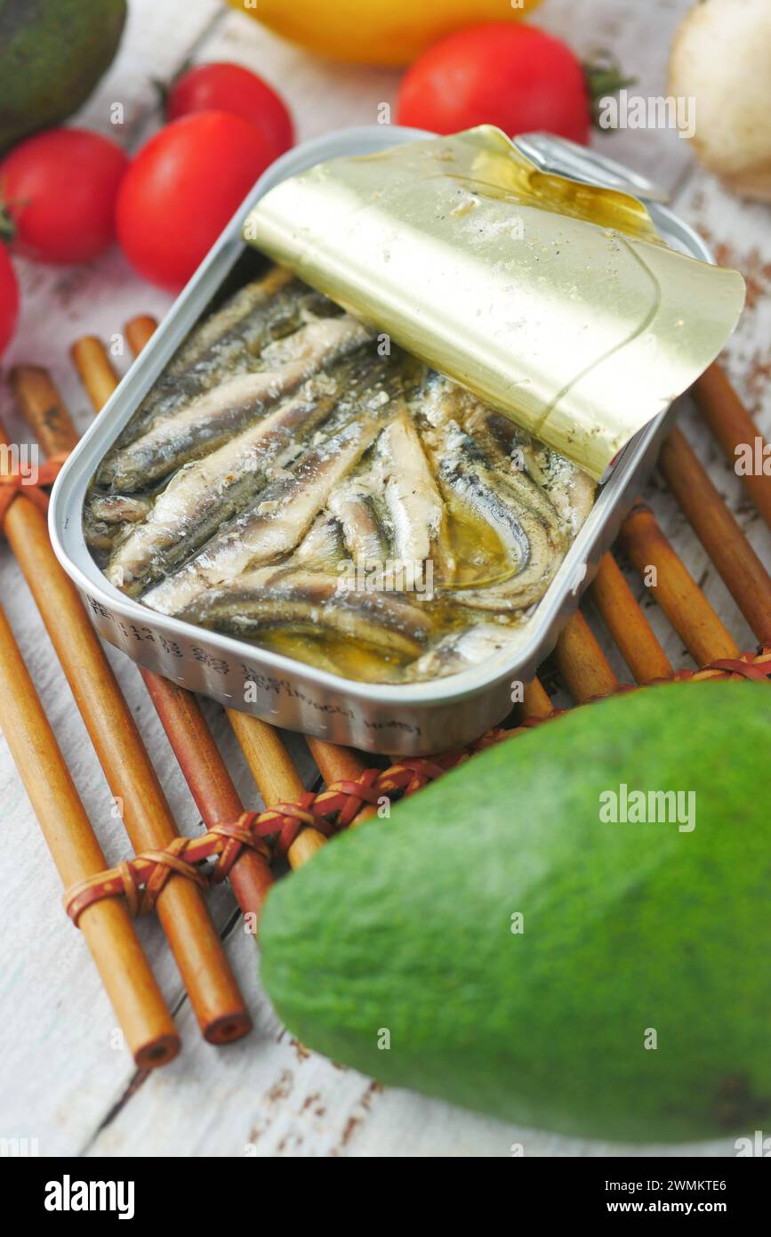open tin of sardines on white tiles background Stock Photo - Alamy