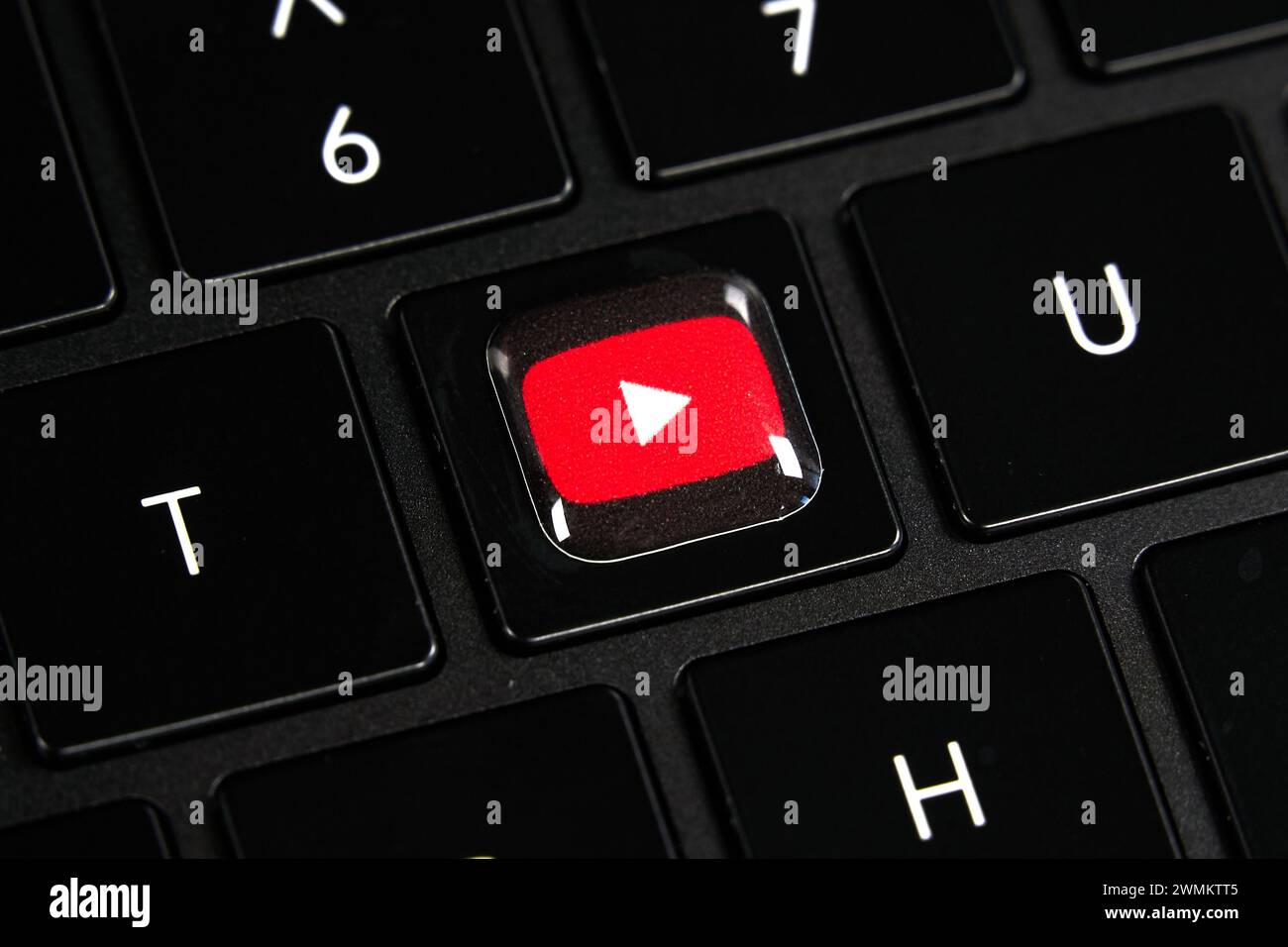 Dallas, TX USA - February 24, 2024: Youtube logo red button on Y key on laptop keyboard. Tech giant Google focuses on AI, search, software, and more, Stock Photo