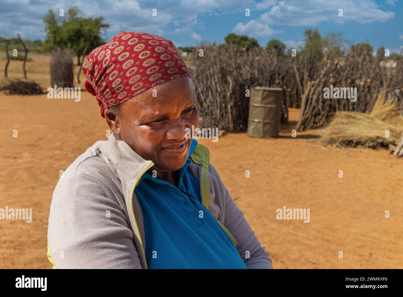 village old african woman in front of the outdoors kitchen next to her home Stock Photo