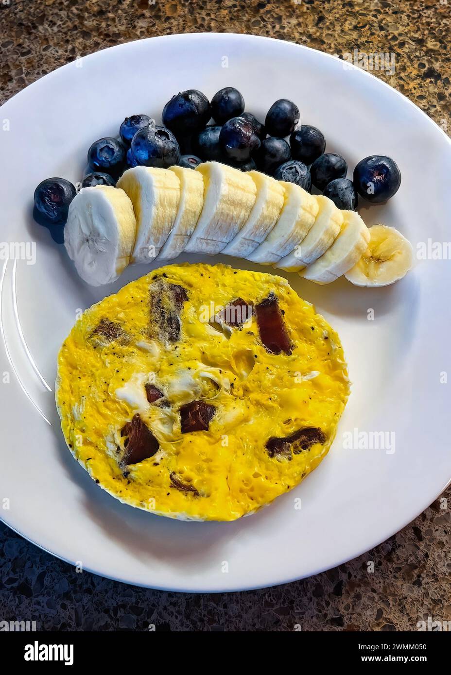 Single egg microwaved omelet filled with chopped dates and served with