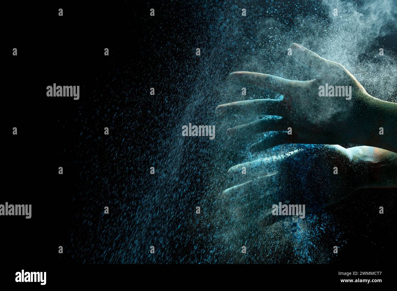 Human hand with colorful Holi powder on a black background. Holi ...