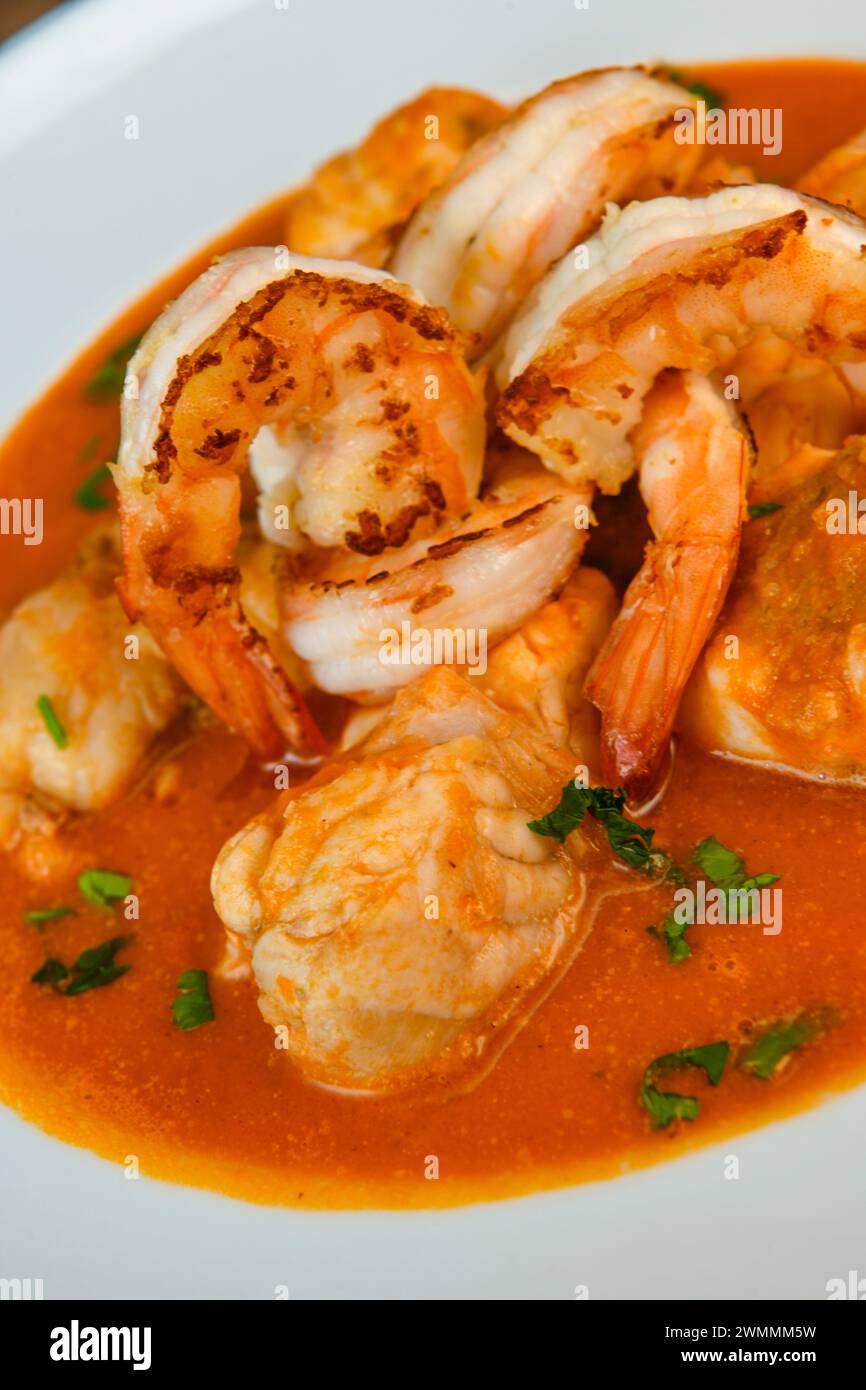 Recipe for Armorican-style monkfish tail, prawns, flambees with cognac Stock Photo