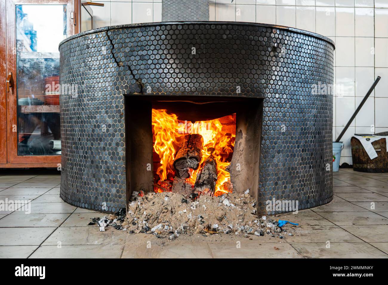 the fire heats up a large cooking pot. Stock Photo