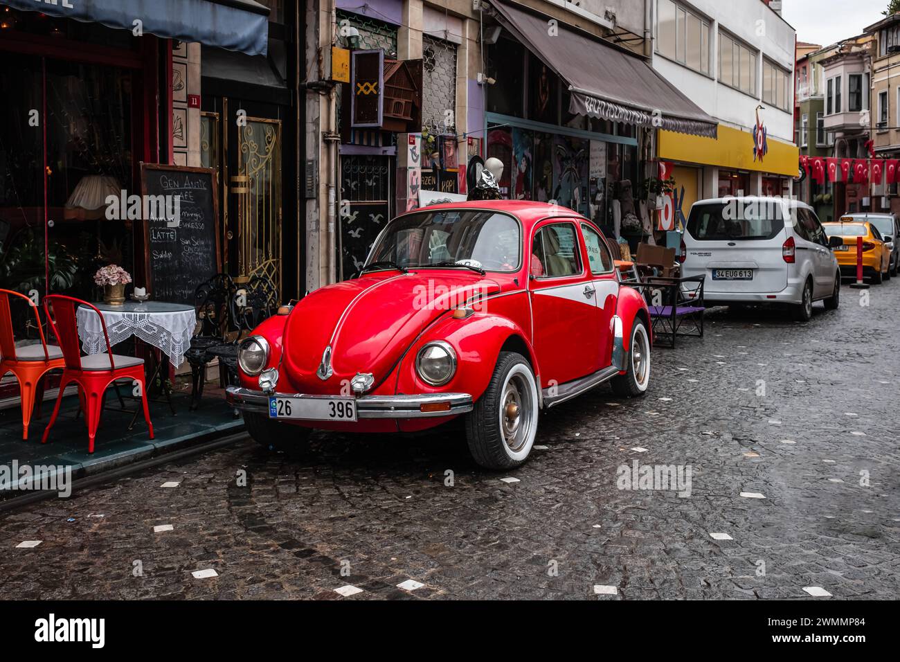 Red old car in the streets of Istanbul Turkey. Classic vintage car parked in the old city. Red car on the empty urban street in a cloudy day. Street v Stock Photo