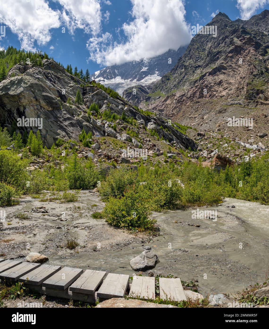 The glacial watercourse and stream under Dom peak - Sas Fee. Stock Photo