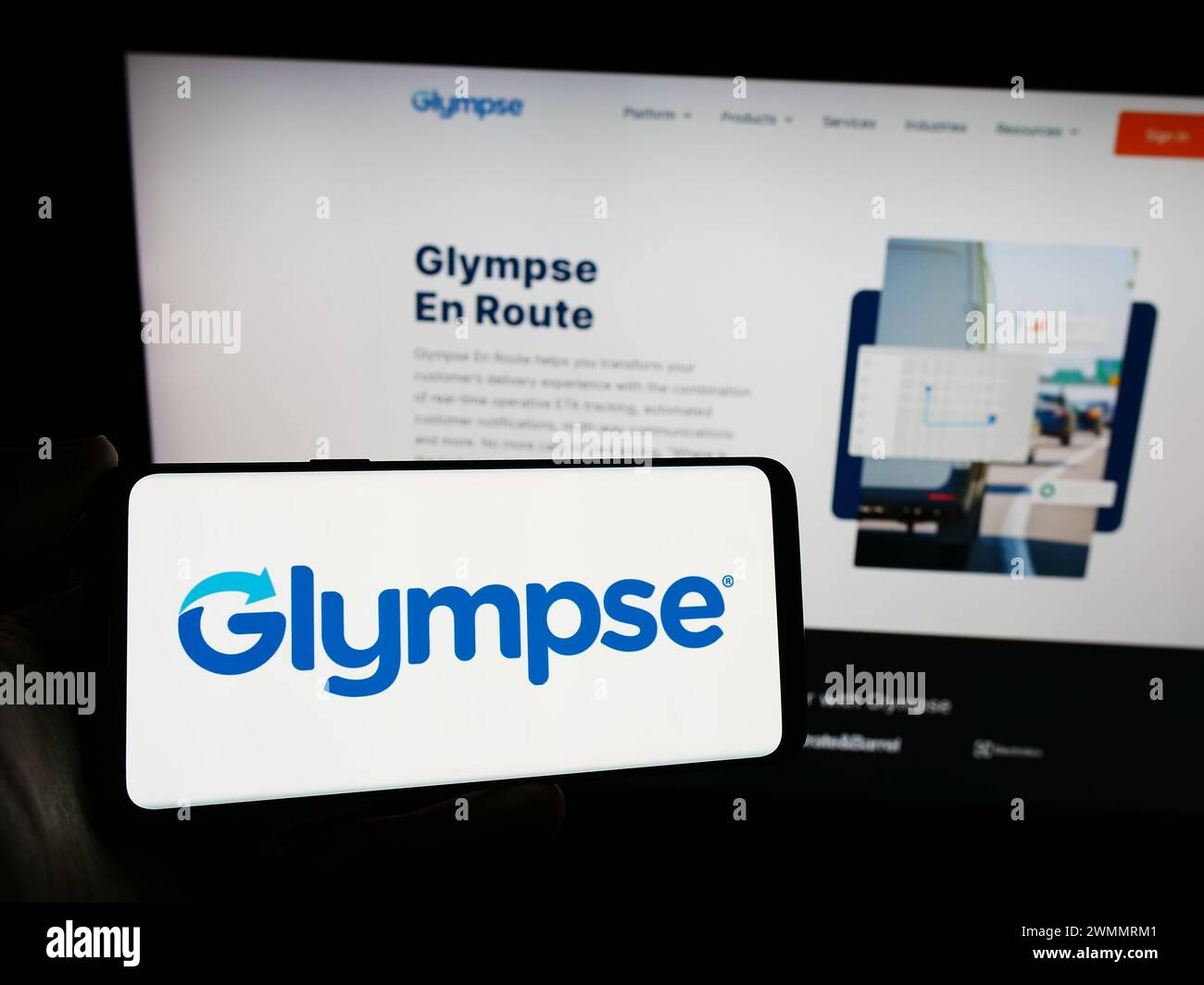 Person holding smartphone with logo of US geo-location tracking company Glympse Inc. in front of website. Focus on phone display. Stock Photo